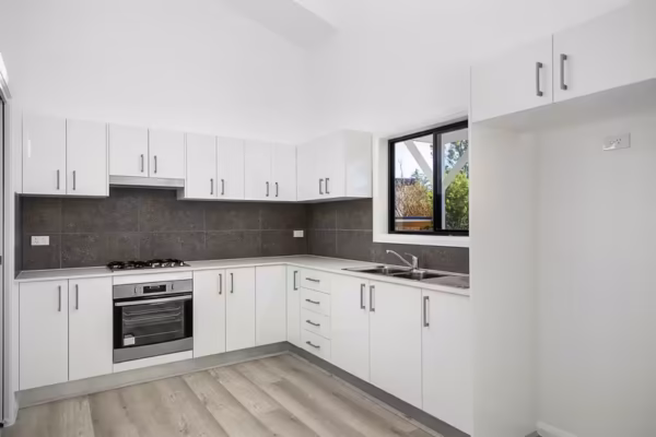 Granny-flat-Sydney-Polyurethane-kitchen-design-rakedceiling-Vinyl-flooring-tiled-splashback