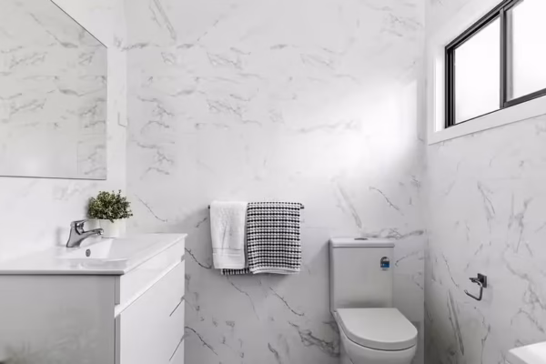 granny-flat-sydney-bathroom-design-floor-to-ceiling-gloss-tiles-Ostar-vanity-mirror-wall